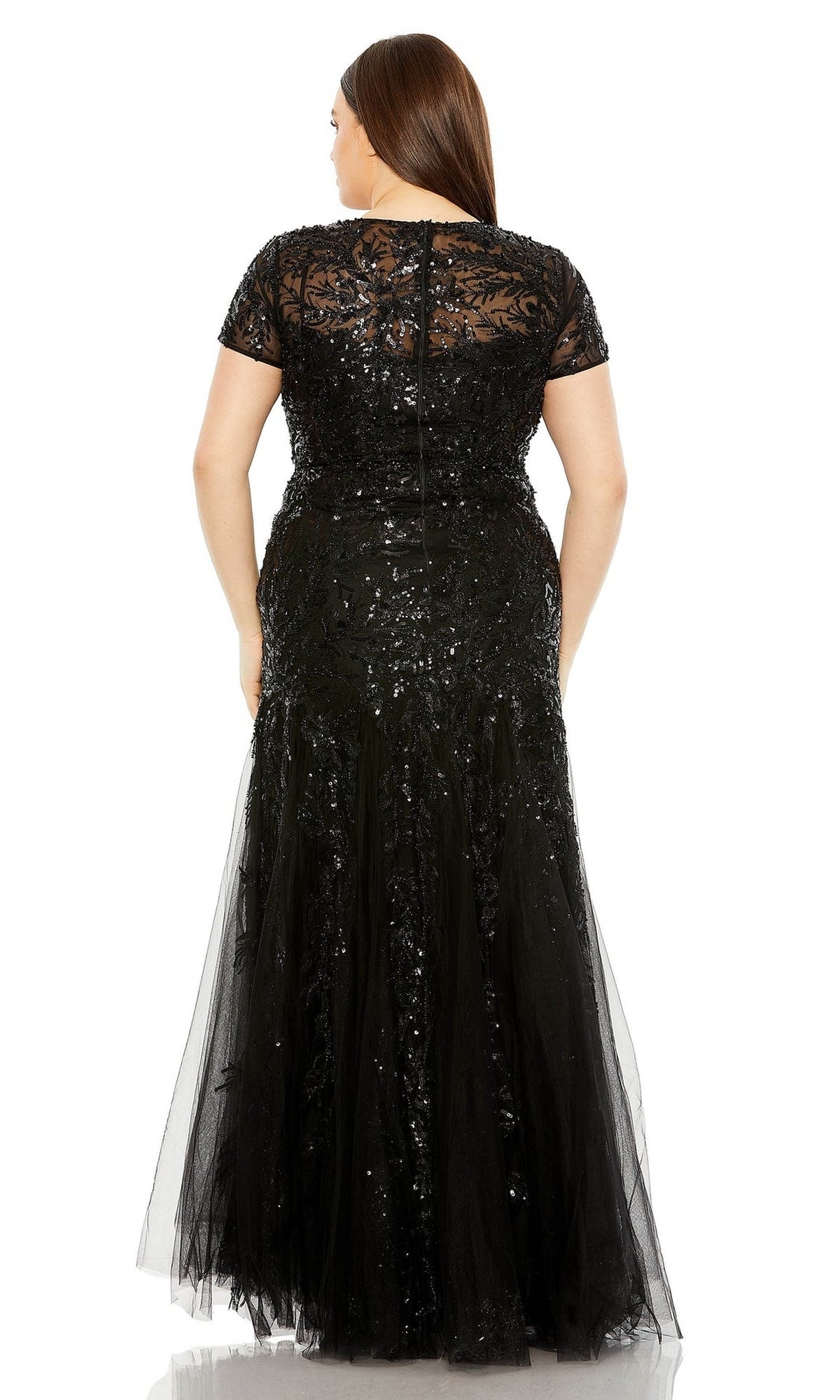 A woman is shown from the back wearing the Long Plus-Size Prom Dress 20623 by Mac Duggal, a floor-length, short-sleeved sequin dress with lace details, perfect for formal occasions.
